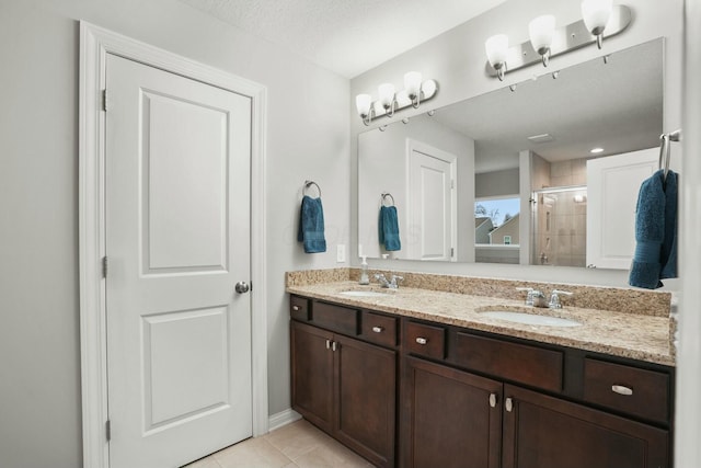 bathroom featuring an enclosed shower, vanity, and tile patterned floors