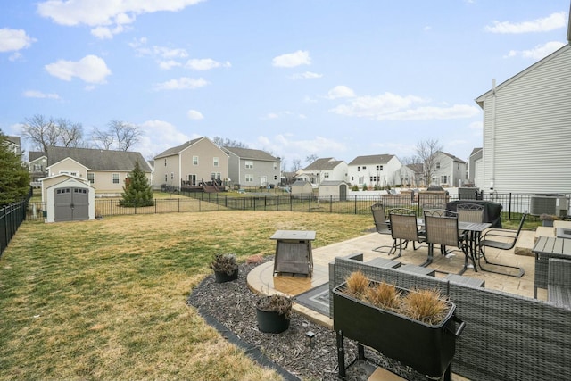 view of yard with an outdoor fire pit, a shed, and a patio