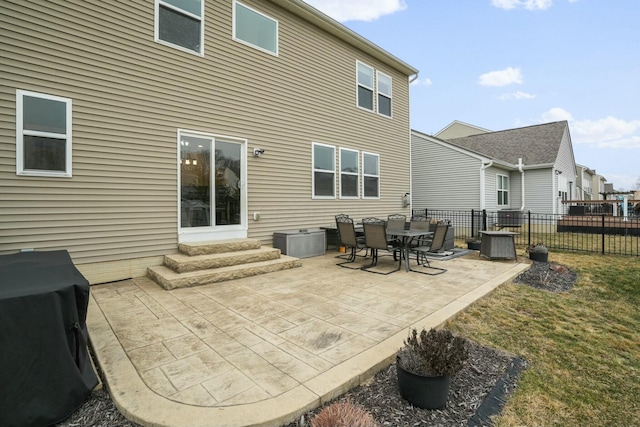 back of house featuring a patio and a lawn