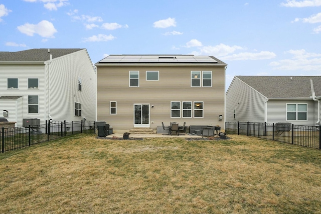 back of property with central AC, a patio, a lawn, and solar panels