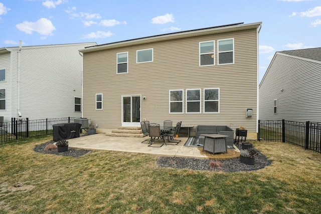 rear view of property featuring a yard and a patio