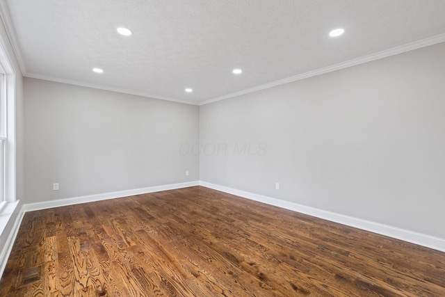 unfurnished room with recessed lighting, visible vents, dark wood-type flooring, ornamental molding, and baseboards