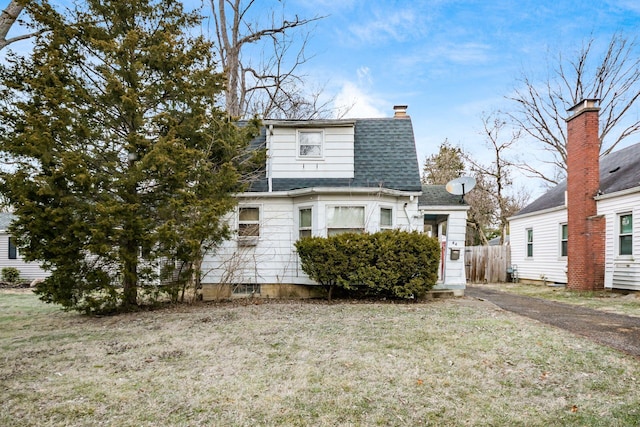 view of property exterior with a lawn