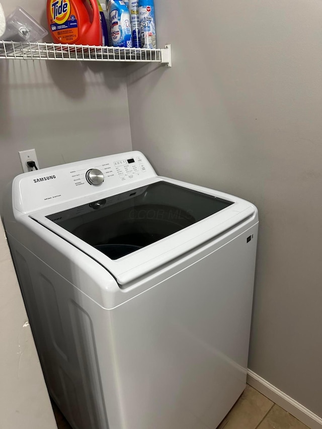 laundry room featuring tile patterned floors and washer / dryer