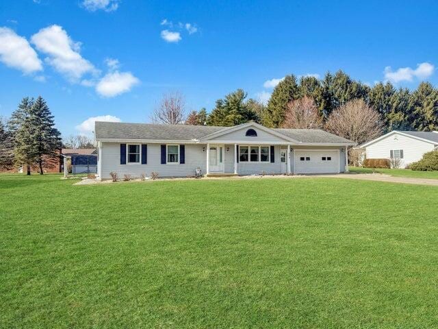 single story home with a front lawn, a garage, and driveway