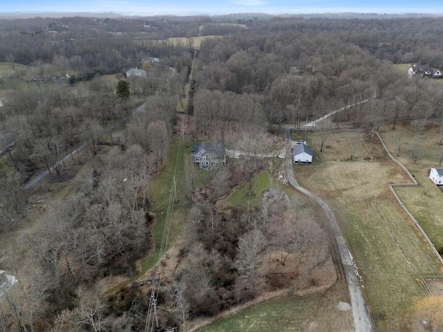 drone / aerial view featuring a wooded view and a rural view