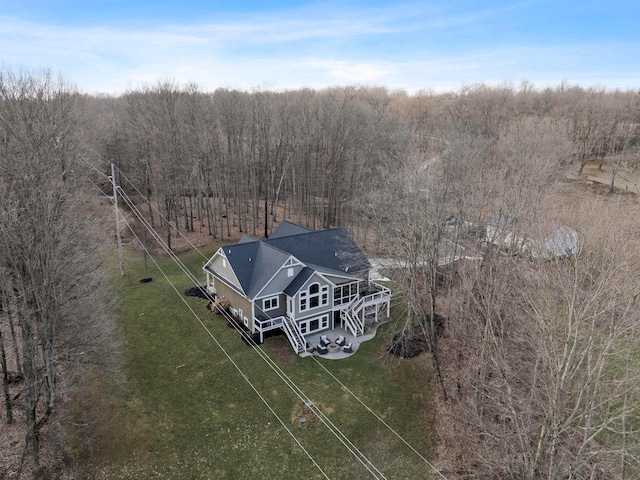 drone / aerial view featuring a rural view and a view of trees