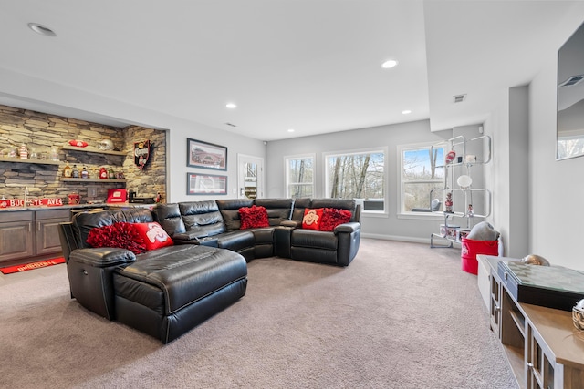 living area with light carpet, visible vents, and recessed lighting