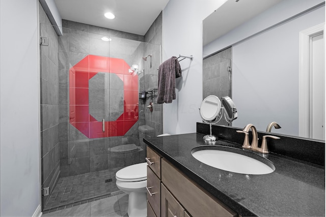 full bathroom featuring a stall shower, vanity, and toilet