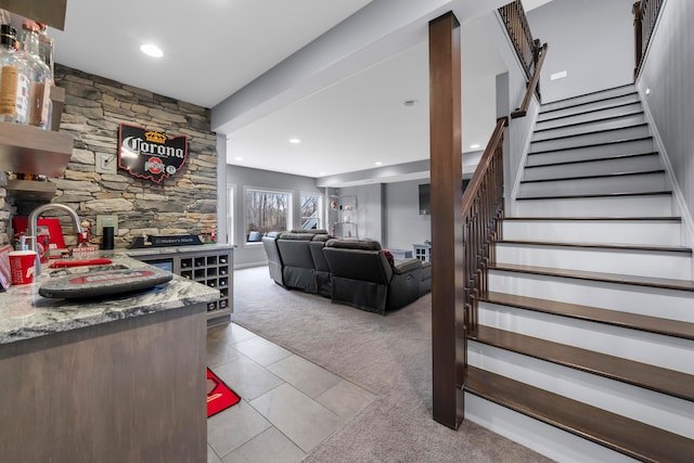 living area featuring light tile patterned floors, recessed lighting, light carpet, and stairs