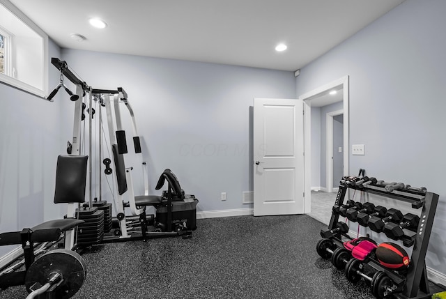 exercise area featuring baseboards and recessed lighting