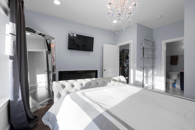 bedroom featuring a chandelier and wood finished floors