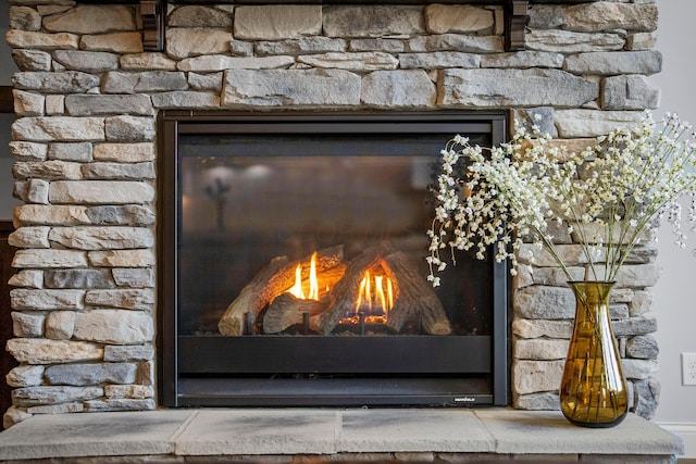 room details featuring a glass covered fireplace