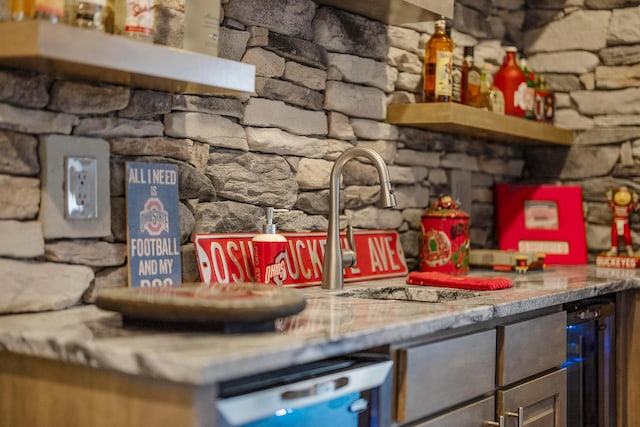 interior space featuring a sink, dishwasher, and a dry bar