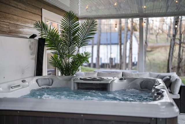 sunroom / solarium featuring a jacuzzi