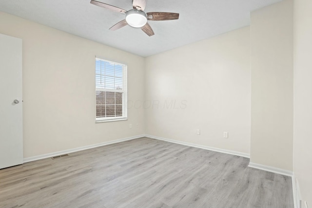 spare room featuring ceiling fan and light wood-type flooring