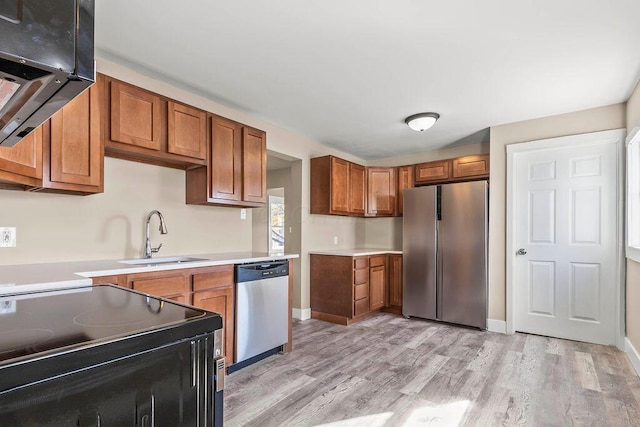 kitchen featuring light hardwood / wood-style flooring, stainless steel appliances, and sink