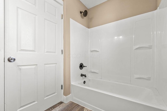 bathroom with shower / tub combination and hardwood / wood-style floors