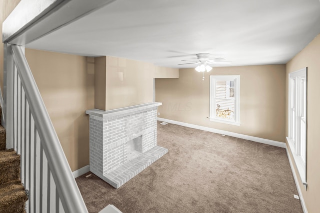 living room with carpet, ceiling fan, and a fireplace