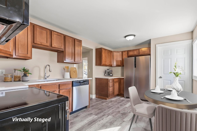 kitchen featuring light hardwood / wood-style floors, appliances with stainless steel finishes, and sink