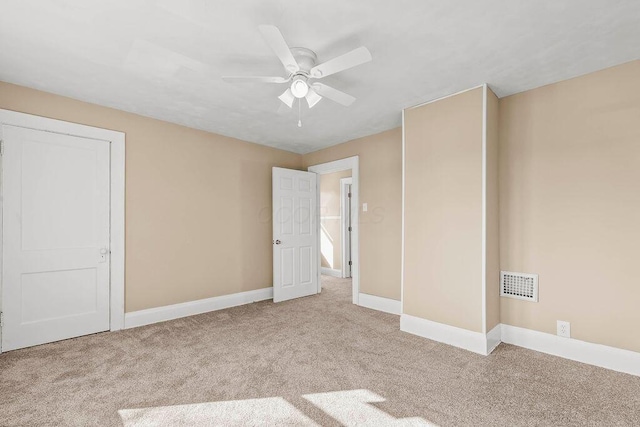 unfurnished bedroom with light carpet and ceiling fan