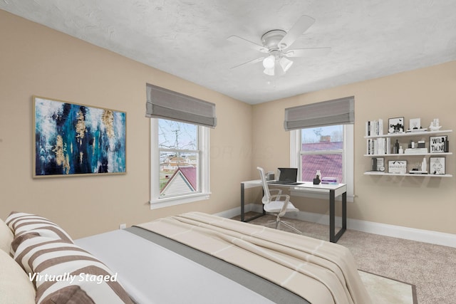 bedroom with multiple windows, carpet, ceiling fan, and a textured ceiling