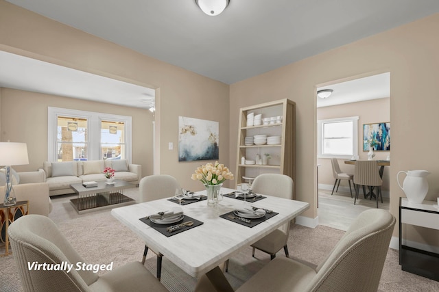 dining area featuring light carpet