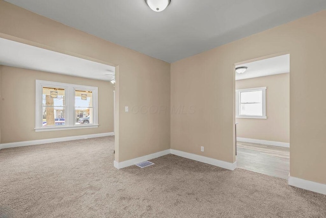 unfurnished room with light colored carpet