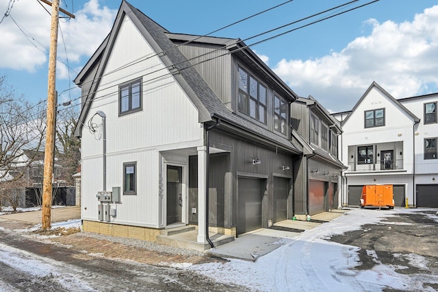 view of front facade with a garage and roof with shingles