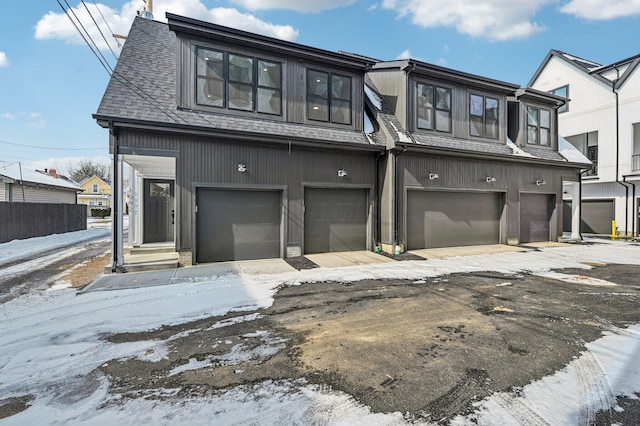 view of front of house featuring roof with shingles and an attached garage