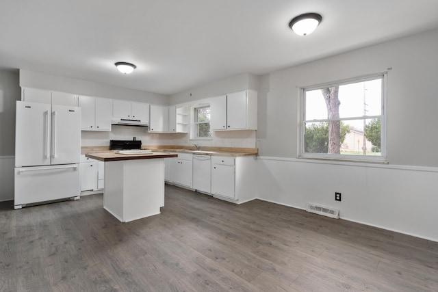 kitchen featuring a kitchen island, dark hardwood / wood-style floors, wood counters, white cabinets, and white appliances