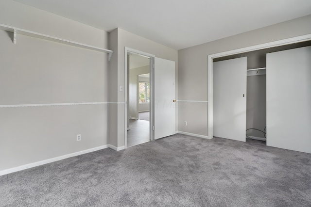 unfurnished bedroom featuring carpet floors and a closet