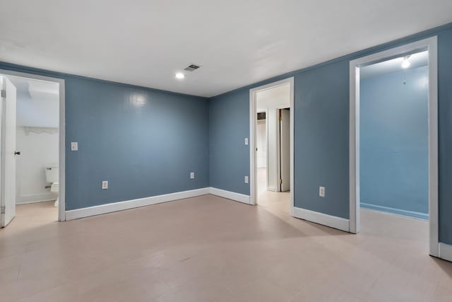 unfurnished bedroom featuring connected bathroom, a spacious closet, and a closet