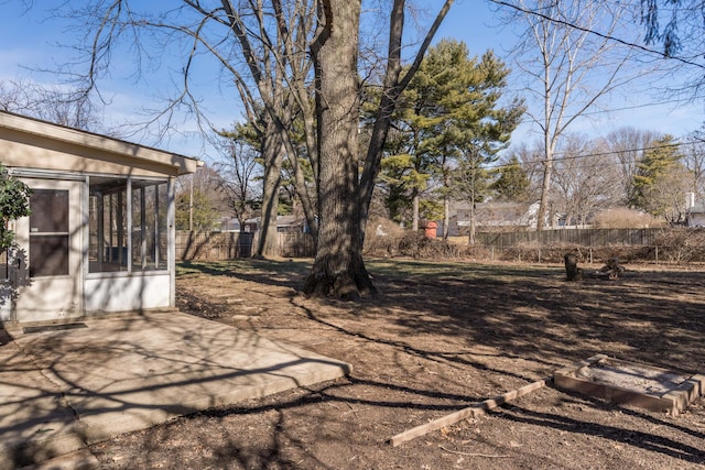 view of yard with a sunroom and a patio area