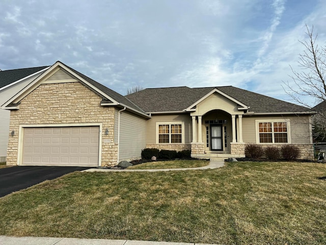 view of front of house with a garage and a front yard