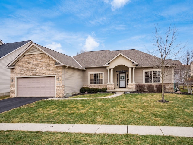 view of front facade with a garage and a front lawn