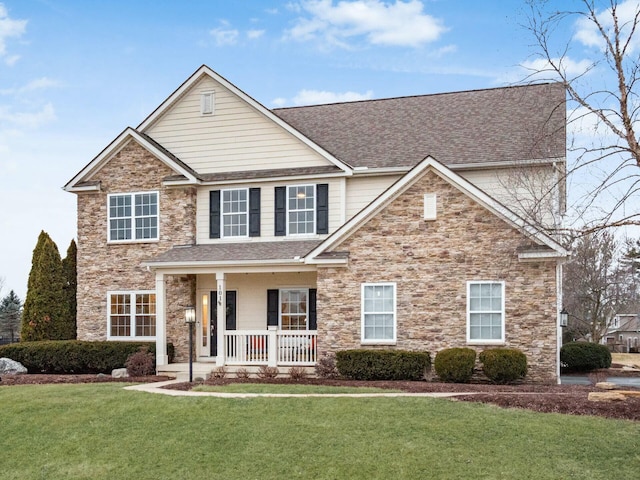 view of front of home featuring a front yard and covered porch