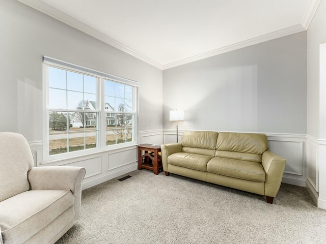 carpeted living room featuring ornamental molding