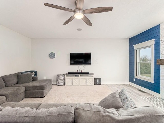 living room with ceiling fan and light hardwood / wood-style flooring