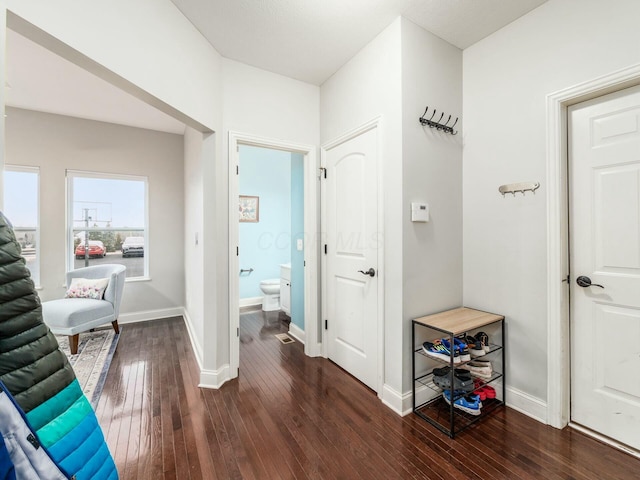 hallway with dark wood-type flooring