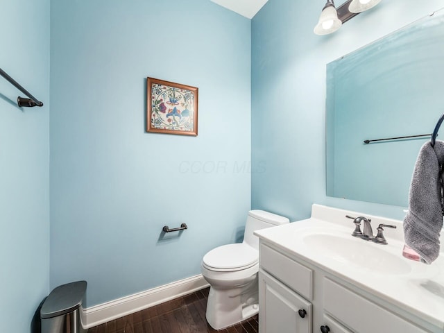 bathroom featuring hardwood / wood-style flooring, vanity, and toilet