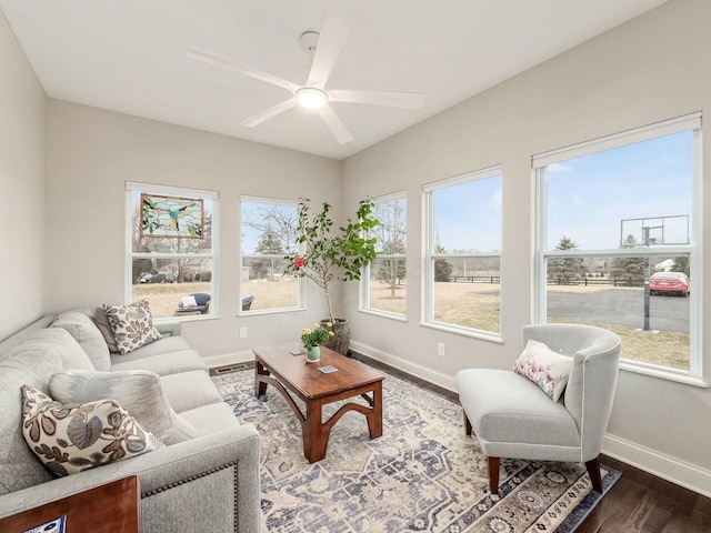 living room featuring ceiling fan and dark hardwood / wood-style floors