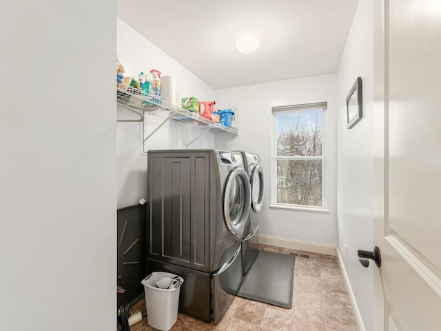 clothes washing area with separate washer and dryer