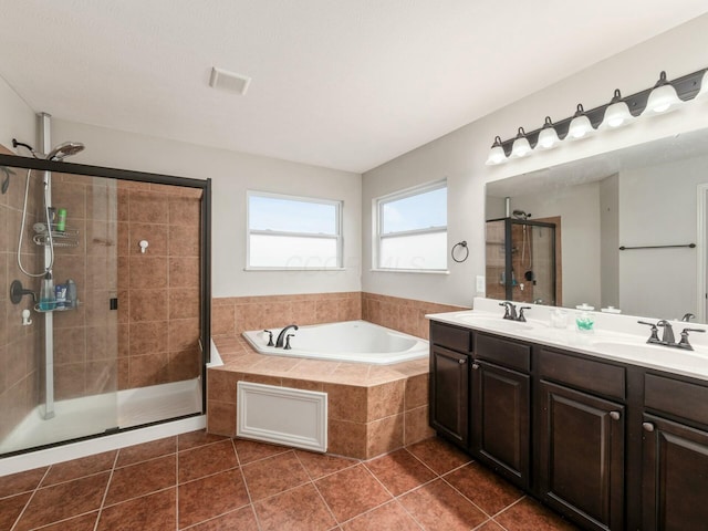 bathroom featuring tile patterned floors, separate shower and tub, and vanity