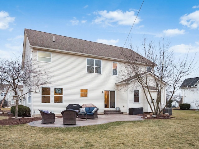 rear view of property featuring an outdoor living space, a patio area, and a lawn