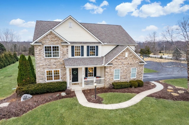 view of front property with a porch and a front lawn