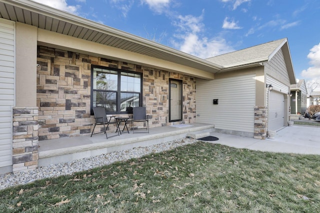 property entrance with a garage and a lawn