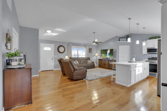 living room featuring lofted ceiling, light hardwood / wood-style flooring, and ceiling fan