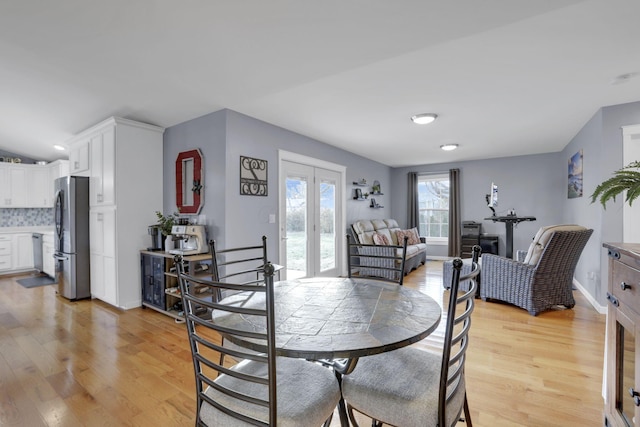 dining room with french doors and light wood-type flooring