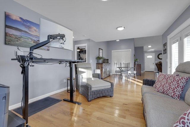 living room with wood-type flooring and ceiling fan